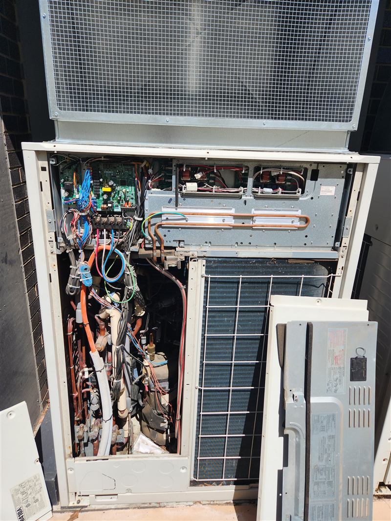 A VRV outdoor unit with its front panels removed for servicing